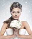 Portrait of a young bride holding white flowers