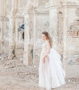 Portrait of a young bride in white lace boudoir with wavy dark hair