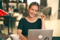 Portrait of young brown hair business woman sitting at desk table in the office, working at home, using laptop computer Royalty Free Stock Photo