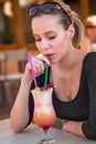 Portrait of young brunette beauty with a drink on the table Royalty Free Stock Photo