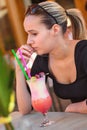 Portrait of young brunette beauty with a drink on the table Royalty Free Stock Photo