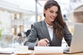 Portrait of a young brunette business woman using laptop at office Royalty Free Stock Photo