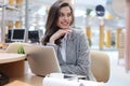 Portrait of a young brunette business woman using laptop at office Royalty Free Stock Photo