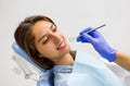 Portrait of young brunette female patient smiling in dentistry
