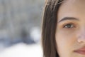 Portrait of a young brunette girl. Half face