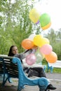 Portrait of young  brunette teenager girl with balloons in the park Royalty Free Stock Photo