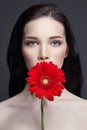 Portrait of young brunette woman against a dark background. Mysterious bright image of a woman with professional makeup