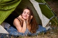 Young brunette woman lying in tent with her eyes closed Royalty Free Stock Photo