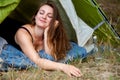 Young brunette woman lying in tent with her eyes closed Royalty Free Stock Photo