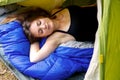 Young brunette woman lying in tent and sleeping Royalty Free Stock Photo