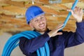 portrait young builder holding reel polyurethane cable Royalty Free Stock Photo