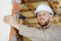 Portrait young builder using hammer on brick wall Royalty Free Stock Photo