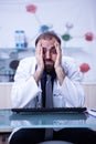 Portrait of young burnout doctor in his hospital cabinet