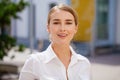 Portrait, young business blonde in white shirt on summer street Royalty Free Stock Photo