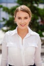 Portrait, young business blonde in white shirt on summer street Royalty Free Stock Photo
