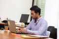 Portrait of Young business indian man working with laptop Royalty Free Stock Photo