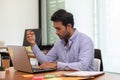 Portrait of Young business indian man working with laptop thinking business plan Royalty Free Stock Photo