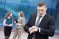 Portrait of young business man looking at watch