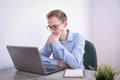 Portrait of young business man sitting at his desk desktop laptop technology in the office.Internet marketing, finance, business Royalty Free Stock Photo