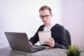 Portrait of young business man sitting at his desk desktop laptop technology in the office.Internet marketing, finance, business Royalty Free Stock Photo