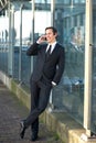 Portrait of a young business man talking on mobile phone outdoors Royalty Free Stock Photo