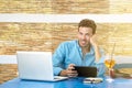 Portrait of young Business man working with laptop and tablet during vacation. remote. New trends tech concept Royalty Free Stock Photo