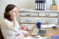 Portrait of young business mom having headache because of crying Royalty Free Stock Photo