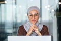 Portrait of young business woman in hijab, muslim woman close up smiling and looking at camera, arab woman in glasses Royalty Free Stock Photo