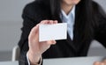 Portrait of young business woman holding blank white business card Royalty Free Stock Photo