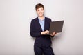 Young business woman holding laptop computer by white background Royalty Free Stock Photo