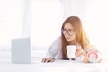 Portrait of a young business woman ,laptop,cup of coffee. Business concept a laptop drinking coffee with her computer on the bed Royalty Free Stock Photo