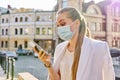 Portrait of young business woman in medical protective mask talking on cellphone Royalty Free Stock Photo