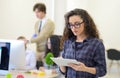 Portrait of young business woman at modern startup office interior, team in meeting in background Royalty Free Stock Photo