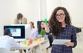 Portrait of young business woman at modern startup office interior, team in meeting in background Royalty Free Stock Photo