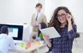 Portrait of young business woman at modern startup office interior, team in meeting in background Royalty Free Stock Photo