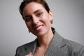 Portrait of young business woman smiling posing over grey background. Positive vibes. Royalty Free Stock Photo