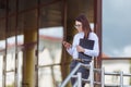 Portrait young business woman wearing white shirt using smartphone out doors. Female reading sms message in working Royalty Free Stock Photo