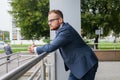 Portrait of young businessman with beard standing in front of of Royalty Free Stock Photo