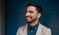 Portrait of young businessman commuter outdoors in city, standing against dark background. Royalty Free Stock Photo