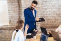 Young businessman giving presentation to his colleagues in office Royalty Free Stock Photo