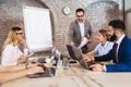 Young businessman giving presentation to his colleagues in office Royalty Free Stock Photo