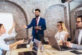 Young businessman giving presentation to his colleagues in office Royalty Free Stock Photo