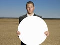 Portrait of young businessman holding blank sign Royalty Free Stock Photo