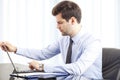 Portrait of young businessman with laptop