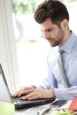 Portrait of young businessman with laptop