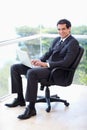 Portrait of a young businessman sitting on an armchair Royalty Free Stock Photo