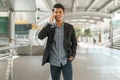 Portrait of young businessman standing at Outside Office and talking on  smartphone. Asian Business man wear suit and handsome Royalty Free Stock Photo