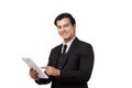 Portrait young businessman working on new tablet, mobile phone in white studio. Portrait of a confident business man in black suit Royalty Free Stock Photo