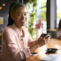 Portrait Of Young Businesswoman With Coffee Working On Laptop Sitting In Cafe Or Office Royalty Free Stock Photo