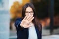 Portrait of young businesswoman disapproval gesture with hand: denial sign, no sign, negative gesture, professional Royalty Free Stock Photo